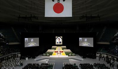 With Flowers and a Gun Salute Japan Bids Farewell to Divisive Abe